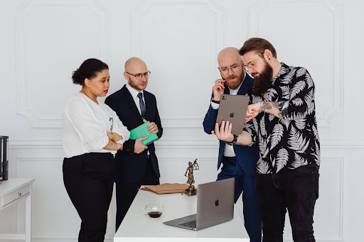 Lawyers discussing professional development and completing mandatory legal CPD courses on a laptop.