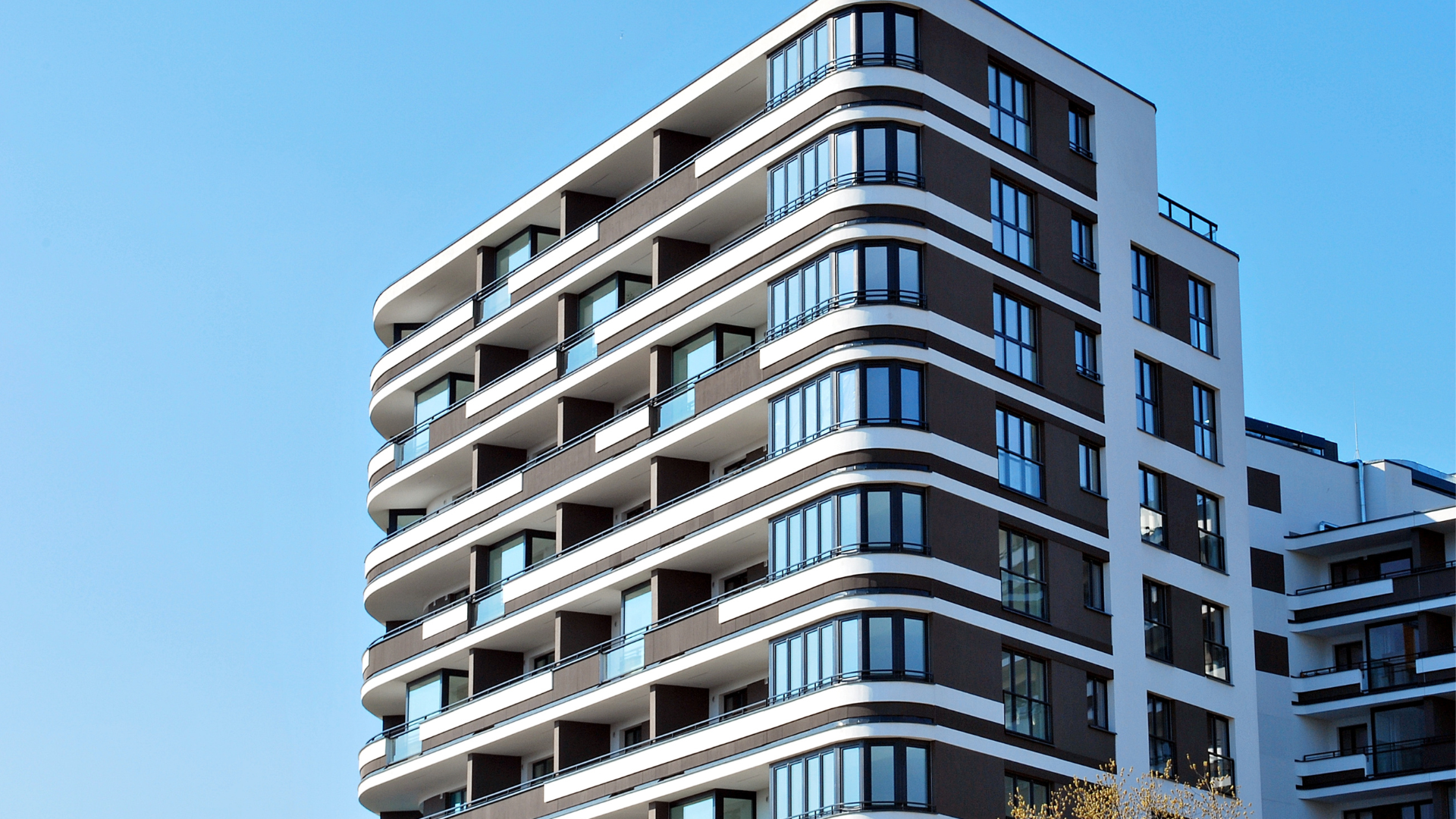 Apartment building with shared strata balconies